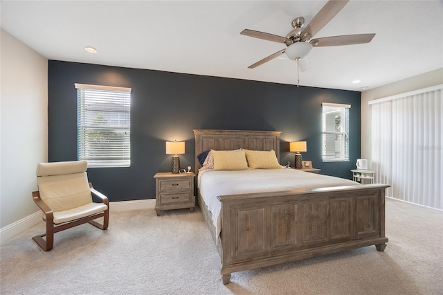 bedroom with light colored carpet, recessed lighting, baseboards, and ceiling fan