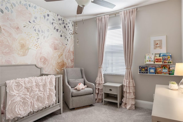 living area with carpet floors, ceiling fan, baseboards, and a wealth of natural light