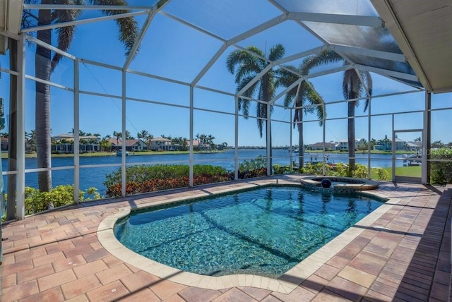 view of swimming pool with glass enclosure, a patio, and a water view