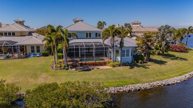 back of property featuring a lawn, a water view, a lanai, and an outdoor pool