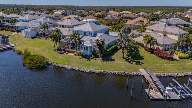 drone / aerial view with a residential view and a water view