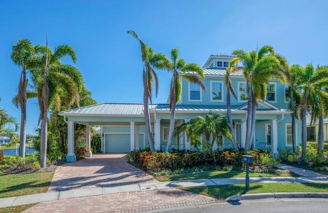 view of front of home featuring metal roof, decorative driveway, and a standing seam roof