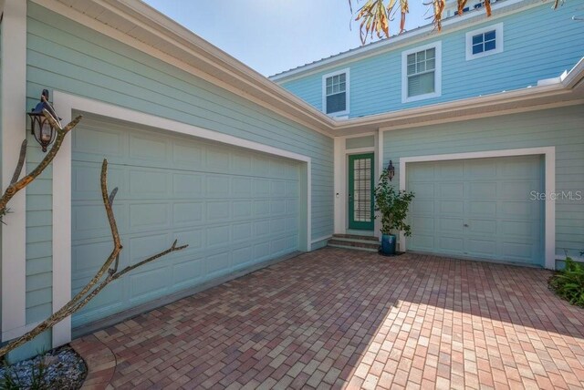 garage featuring decorative driveway