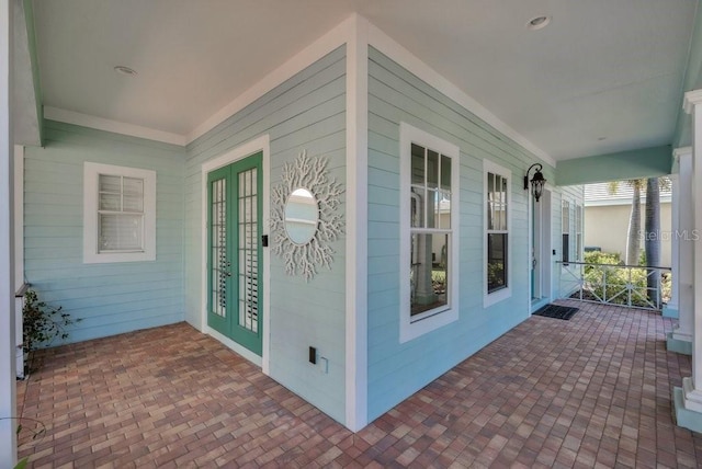 exterior space featuring covered porch and french doors