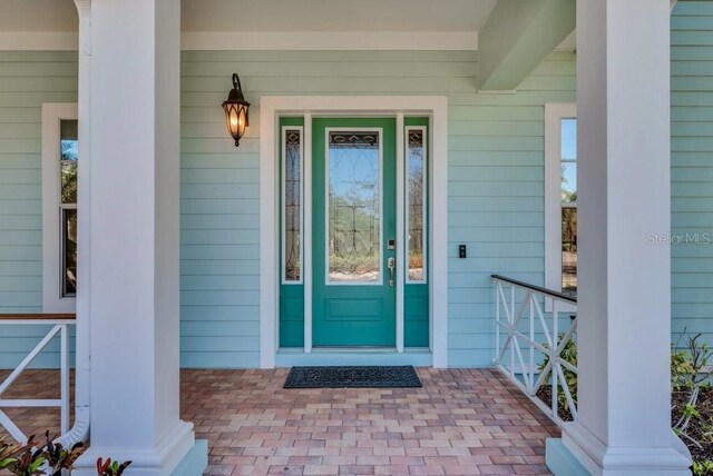 doorway to property featuring covered porch