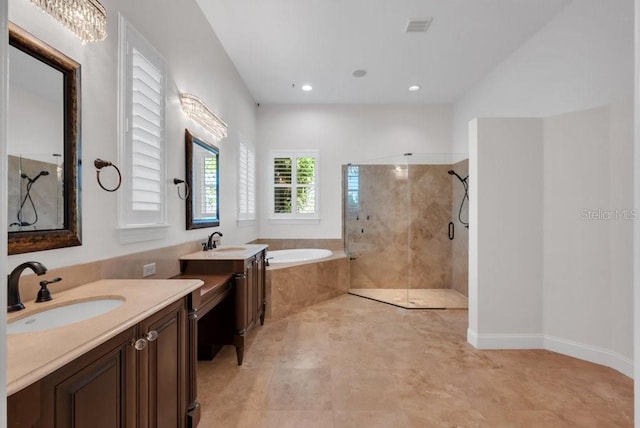 bathroom featuring a bath, visible vents, a tile shower, and a sink