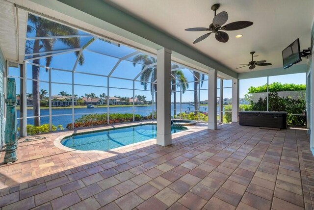 pool with a ceiling fan, a lanai, a patio area, and an outdoor hot tub