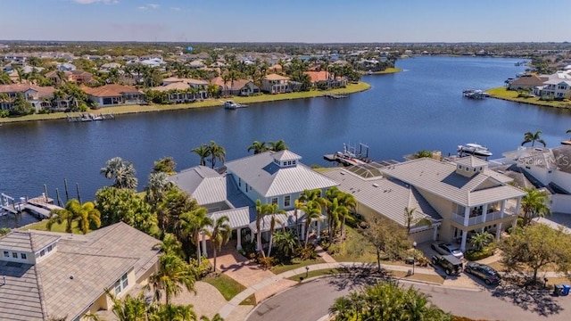 birds eye view of property with a water view and a residential view