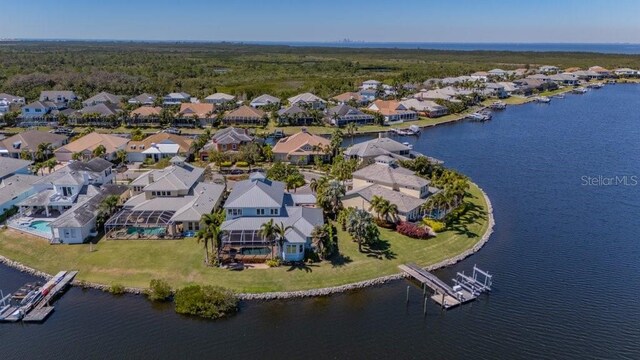 birds eye view of property with a water view and a residential view