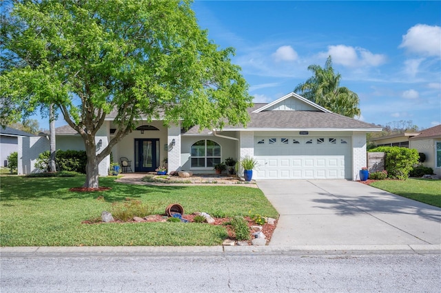 ranch-style house featuring driveway, brick siding, a garage, and a front yard