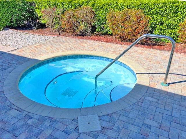 view of pool featuring a community hot tub and a patio area