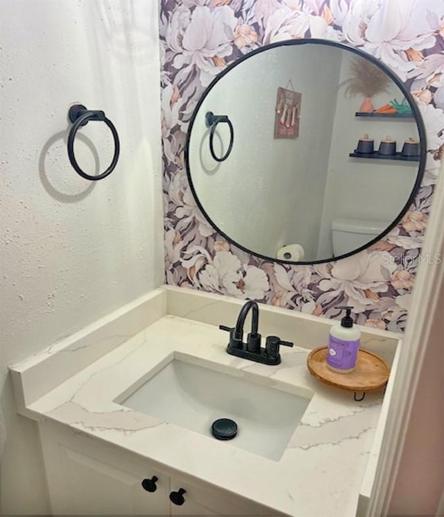 bathroom featuring toilet and vanity