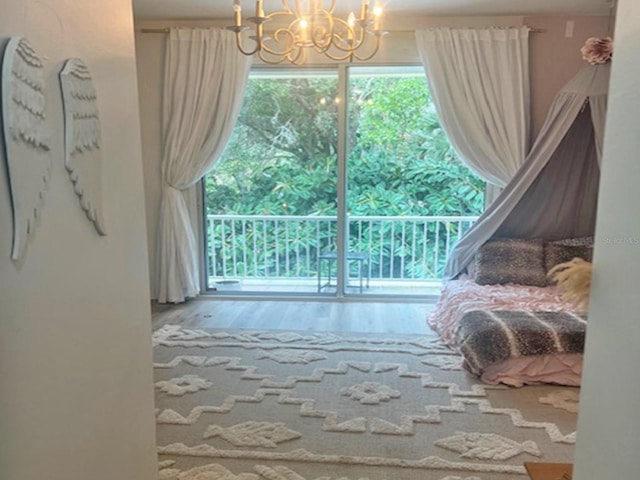 living area with an inviting chandelier and wood finished floors