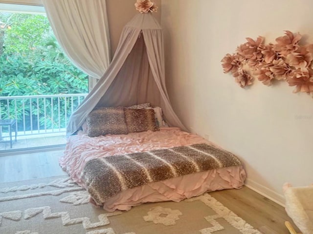 bedroom featuring baseboards and wood finished floors