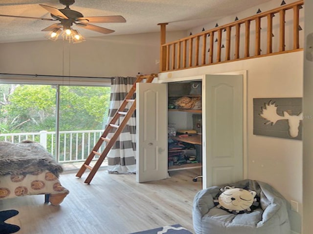 bedroom featuring access to exterior, a textured ceiling, a closet, light wood finished floors, and ceiling fan