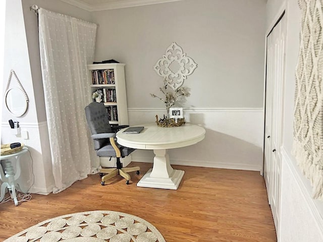 dining area with wood finished floors, baseboards, and ornamental molding