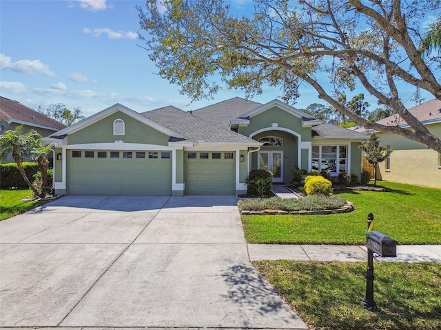 ranch-style house featuring a front yard, roof with shingles, stucco siding, concrete driveway, and a garage