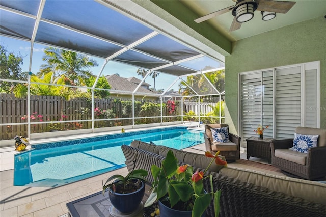 view of swimming pool featuring glass enclosure, a patio, a fenced in pool, a fenced backyard, and an outdoor hangout area