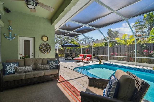 view of swimming pool with a patio, fence, a fenced in pool, ceiling fan, and an outdoor hangout area