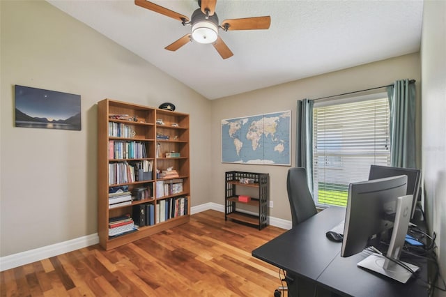 office featuring baseboards, a ceiling fan, lofted ceiling, and wood finished floors