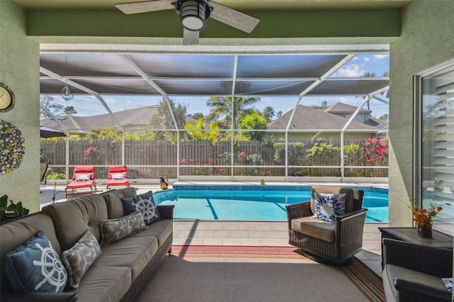 view of pool with a lanai, outdoor lounge area, a patio, and fence