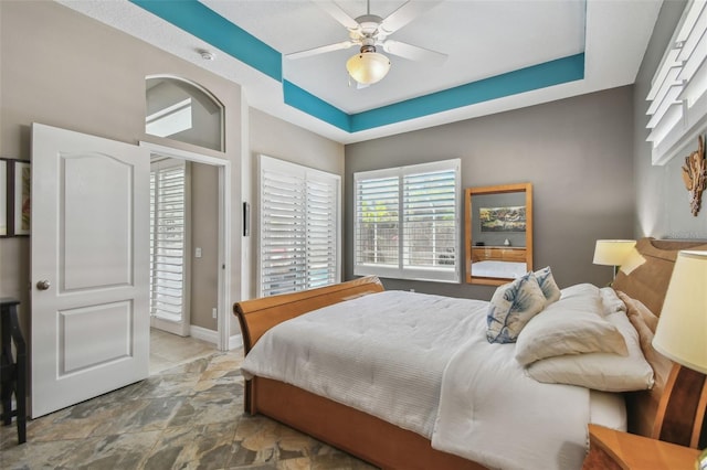 bedroom with baseboards and ceiling fan