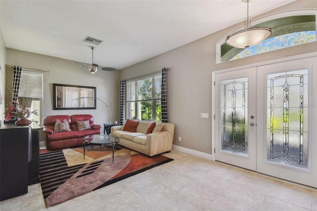 living area featuring visible vents, french doors, and baseboards