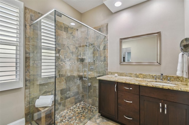 full bathroom with recessed lighting, vanity, and a shower stall