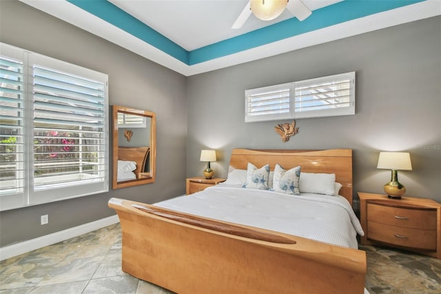 bedroom with multiple windows, baseboards, and ceiling fan