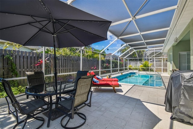 view of swimming pool featuring a fenced in pool, glass enclosure, a fenced backyard, outdoor dining space, and a patio