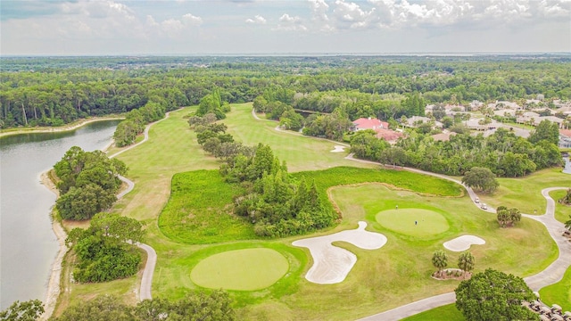 birds eye view of property featuring a forest view, a water view, and view of golf course