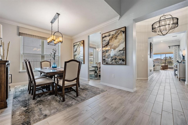 dining area featuring ornamental molding, light wood finished floors, and an inviting chandelier