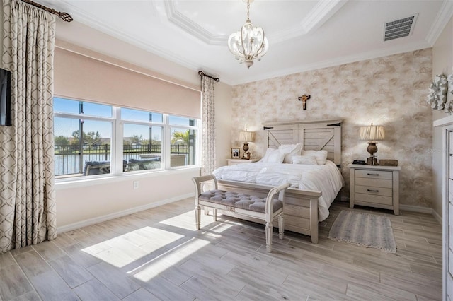 bedroom featuring crown molding, visible vents, a tray ceiling, and wood finish floors