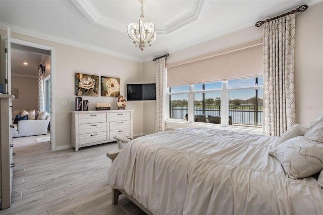 bedroom with baseboards, a raised ceiling, crown molding, light wood-style floors, and a notable chandelier