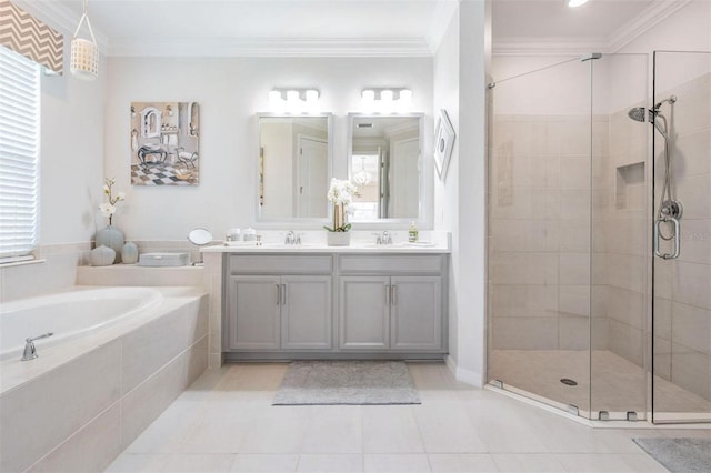 bathroom featuring a garden tub, a shower stall, ornamental molding, and a sink