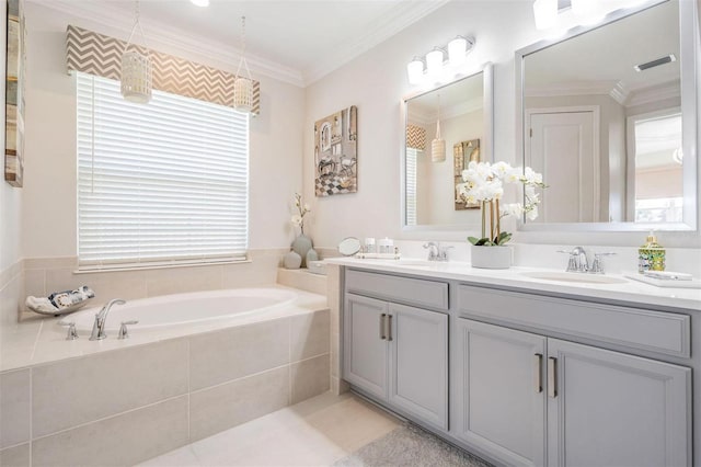 full bathroom with double vanity, a garden tub, ornamental molding, and a sink