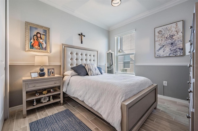 bedroom featuring ornamental molding, wood tiled floor, and baseboards