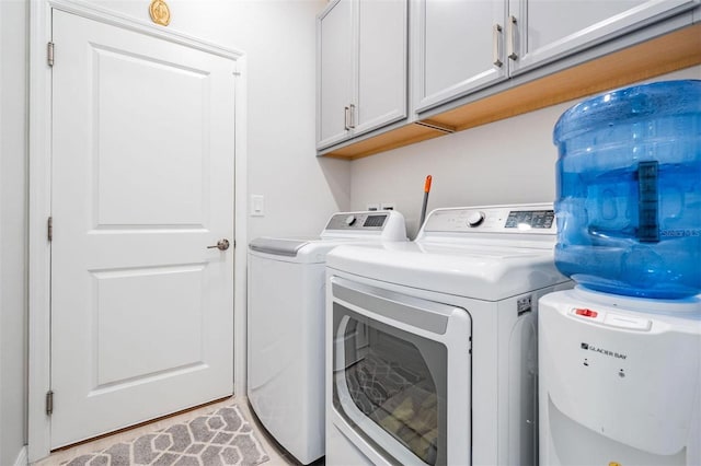 washroom featuring cabinet space and washer and dryer