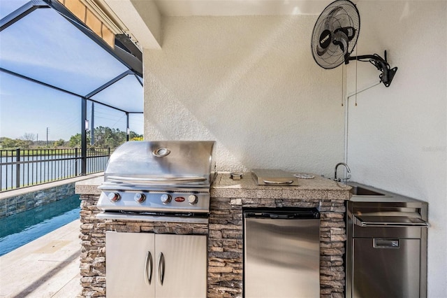 view of patio / terrace with area for grilling, a sink, fence, exterior kitchen, and a lanai