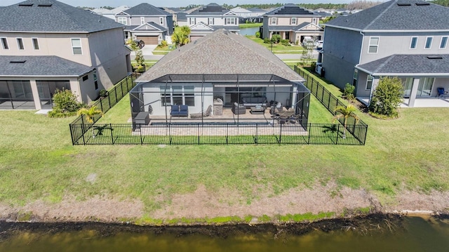 back of property with a patio, a fenced backyard, a lanai, a yard, and a residential view