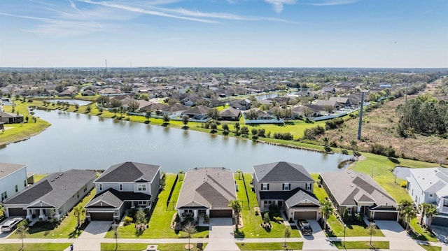 drone / aerial view with a residential view and a water view