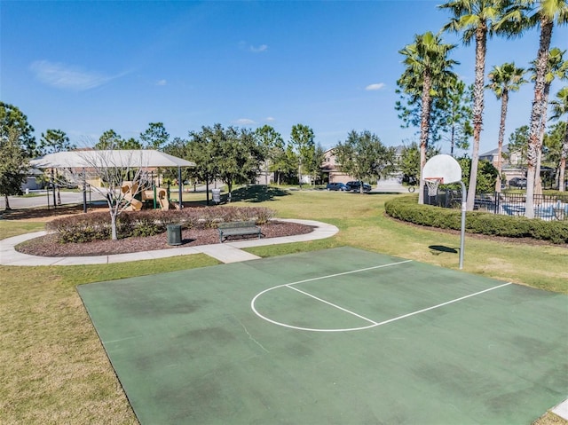 view of basketball court featuring playground community, a lawn, fence, and community basketball court