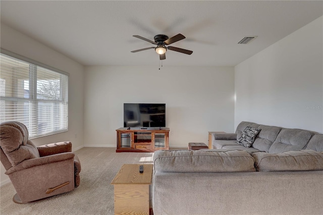 living room featuring ceiling fan, carpet floors, visible vents, and baseboards