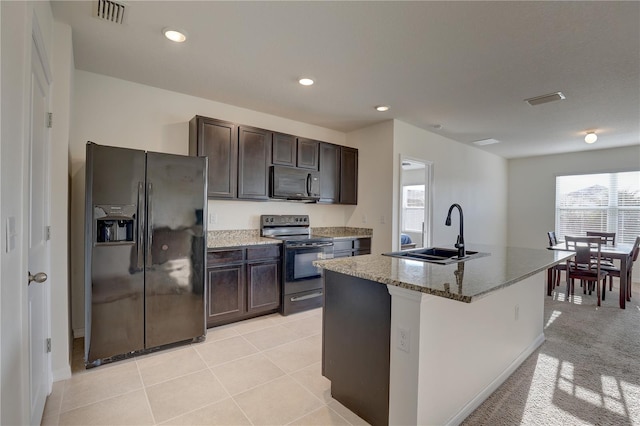 kitchen featuring black appliances, a sink, visible vents, and dark brown cabinetry