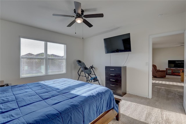 bedroom with carpet flooring, a ceiling fan, and baseboards