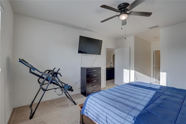 bedroom with light carpet, baseboards, visible vents, a ceiling fan, and a sink