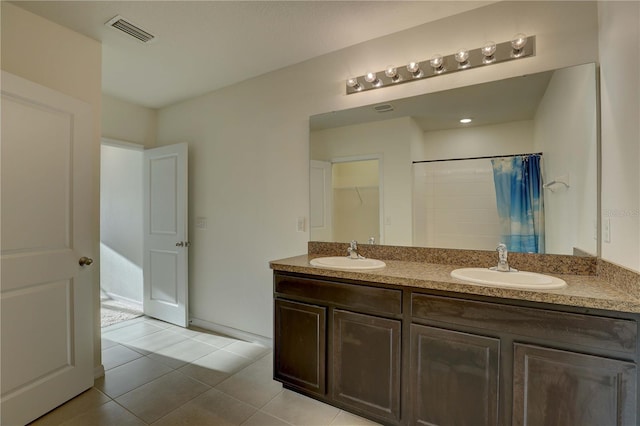 bathroom featuring double vanity, tile patterned flooring, a sink, and visible vents