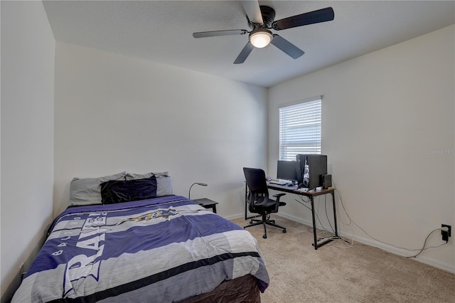 bedroom with light carpet, baseboards, and a ceiling fan