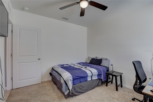 bedroom featuring light carpet, baseboards, visible vents, and ceiling fan