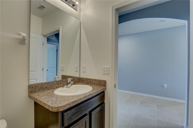 bathroom featuring tile patterned flooring, visible vents, vanity, and baseboards